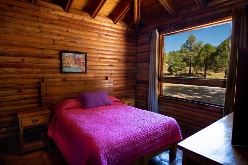 A bed or beds in a room at Molinillos Mountain Resort