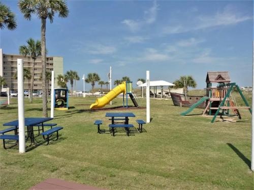 a park with picnic tables and a slide at Pinnacle Port Beach Resort in Panama City Beach