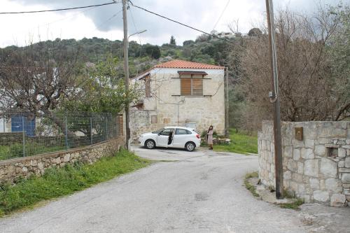a white car parked on the side of a road at Old stone villa in Apokoronas Villa Nostalgia Kreta in Fílippos