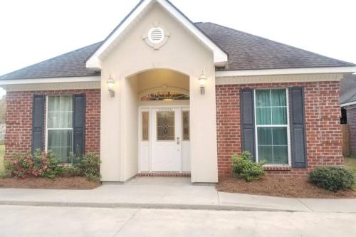 a brick house with a white door at Villa 4 in Hammond