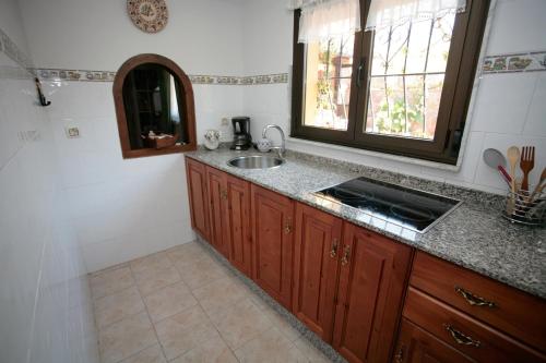 a kitchen with a sink and a counter top at APARTAMENTOS. TURIS. CASTIELLO in Piloña