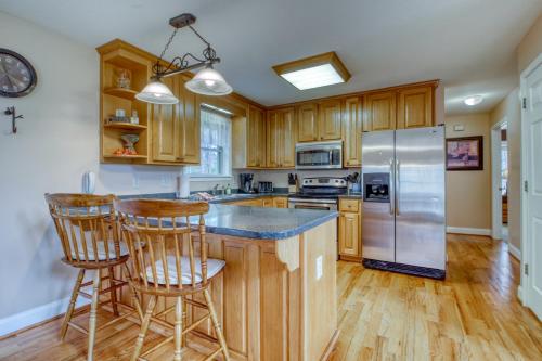 a kitchen with wooden cabinets and a stainless steel refrigerator at Alpine Retreat in Helen