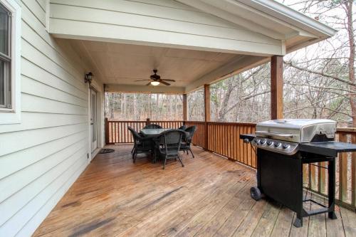 a screened porch with a table and a grill at Alpine Retreat in Helen