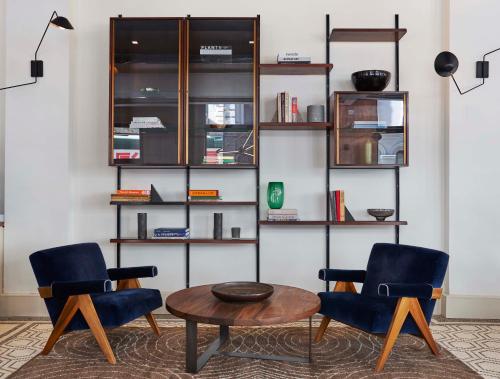 a living room with two chairs and a table at Walker Hotel Tribeca in New York