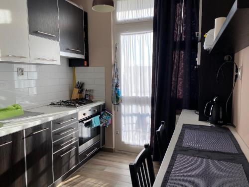 a kitchen with a sink and a stove top oven at City center Zalaegerszeg in Zalaegerszeg