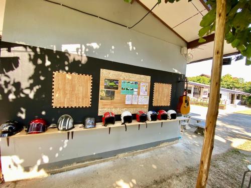a display of baseball caps on a wall at Winter House Chiang Rai in Chiang Rai