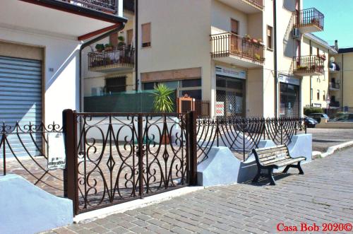 a gate with a bench in front of a building at casa bob alloggio turistico in Fondi
