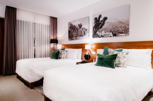 Postel nebo postele na pokoji v ubytování HOTEL MINA REAL MATEHUALA