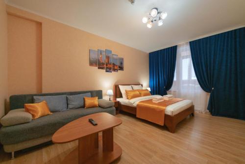 a living room with a couch and a bed at Five Stars Argentina in Nizhnevartovsk