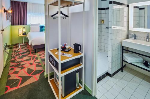 a room with a bathroom with a sink and a toilet at Mercure Paris Orly Airport in Orly