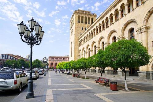 a street with cars parked on a city street at Friendship Hostel & Tours in Yerevan