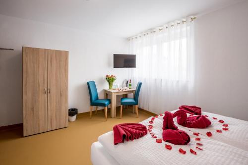 a bedroom with a bed with red pillows on it at Hotel Ludwig in Munich