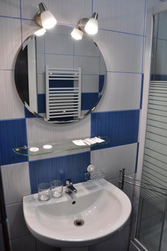 a bathroom with a sink and a mirror at MANEA Orsova in Orşova