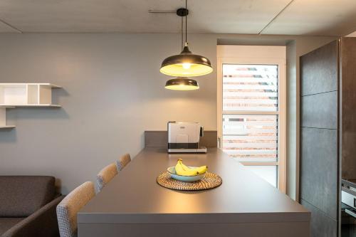 a kitchen with a table with a bowl of bananas on it at Refugium am Wasserturm in Emsdetten