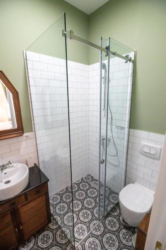 a bathroom with a shower and a toilet and a sink at Seven cafe & hotel in Pogradec