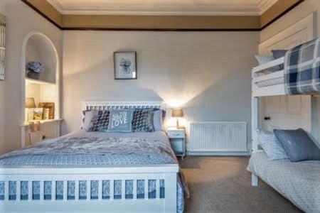 a bedroom with a bed and a bunk bed at The Castle B&B in Inverness