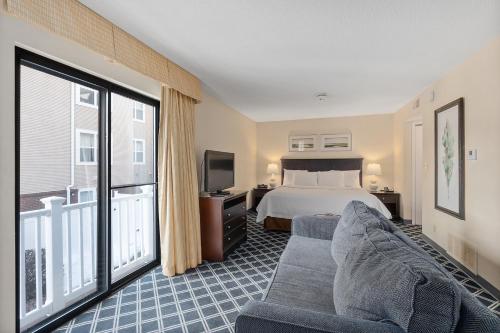 a hotel room with a bed and a tv at Residences at Daniel Webster in Merrimack