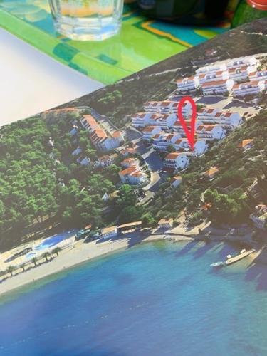 a model of a resort with a beach and water at Apartment Excellent in Nečujam