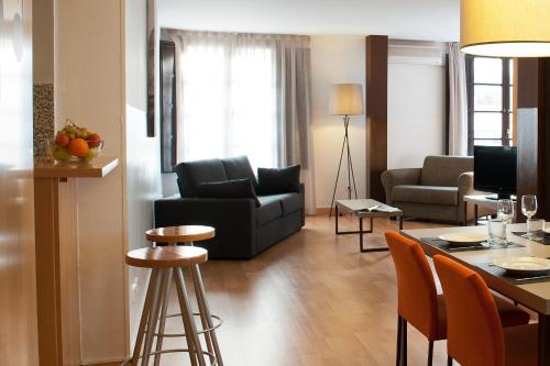 a living room filled with furniture and a coffee table at Aspasios Plaza Real Apartments in Barcelona