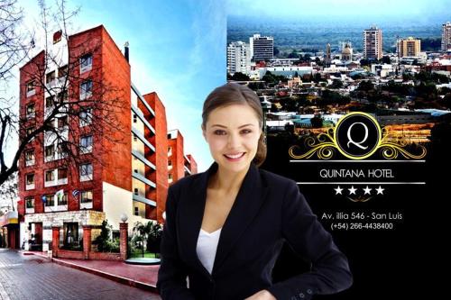 a woman is standing in front of a city at Quintana Hotel in San Luis