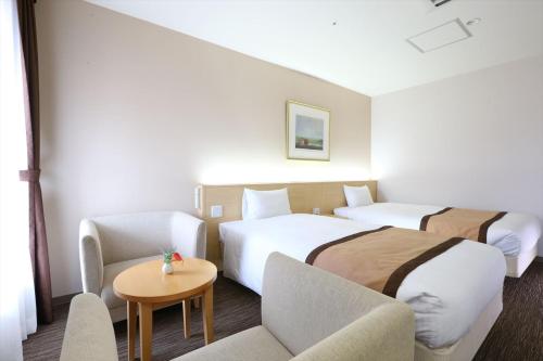 Een bed of bedden in een kamer bij Hotel Hokke Club Kumamoto