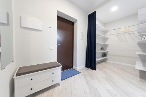 a bathroom with white walls and a brown door at Красивая 1 комнатная квартира с балконом на Теремках 252 in Kyiv