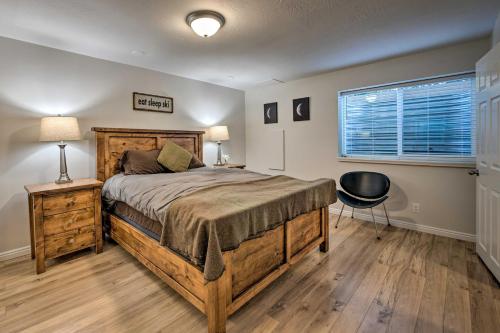 a bedroom with a bed and a chair and a window at Updated Home with Mtn Views 8 Mi to Snowbird Resort in Sandy