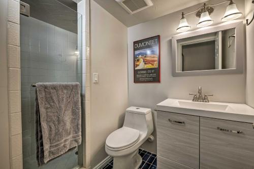 a bathroom with a toilet and a sink and a mirror at Updated Home with Mtn Views 8 Mi to Snowbird Resort in Sandy