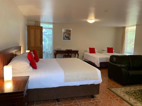 a hotel room with two beds and a couch at Guildford River Retreat in Perth