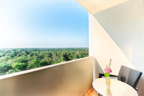 a balcony with a table and chairs and a view at Crowne Plaza Frankfurt Congress Hotel by IHG in Frankfurt/Main