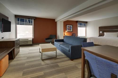 a hotel room with a bed and a couch at Holiday Inn Express Voorhees/ Mt. Laurel by IHG in Voorhees