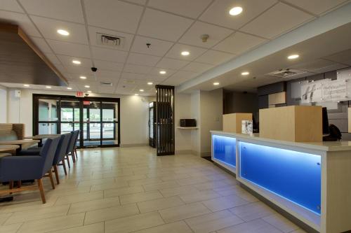 a restaurant with a blue counter and chairs in a room at Holiday Inn Express Voorhees/ Mt. Laurel by IHG in Voorhees