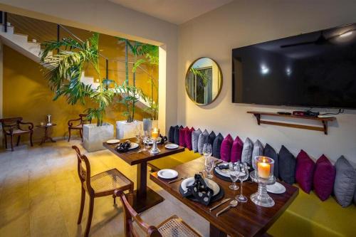 a dining room with a table and a television on a wall at Rosmead Place by Thilanka in Colombo