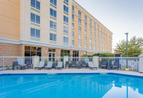 a hotel with a swimming pool in front of a building at Holiday Inn Hotel & Suites Tallahassee Conference Center North by IHG in Tallahassee