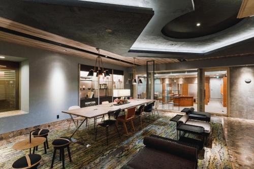a dining room with a long table and chairs at Shin Osaka Esaka Tokyu REI Hotel in Suita