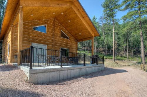 a log cabin with a porch and a balcony at Powder House Lodge in Keystone
