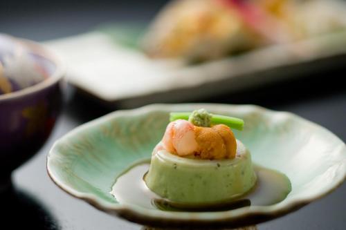 a white plate with a piece of food on it at Kansyokan in Mogami