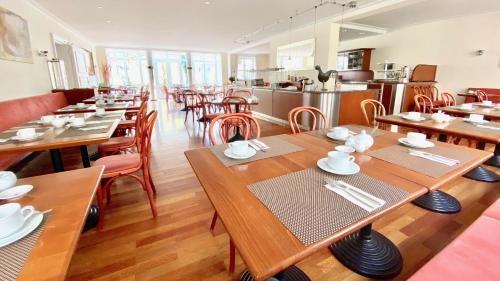 a dining room with wooden tables and chairs at Hotel Alte Post in Mindelheim
