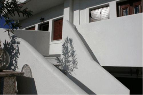 a white staircase in front of a house at Studios Akrogiali in Kyparissia