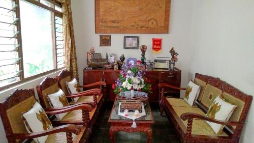 a living room with a table and chairs at Ngampilan Backpacker Hostel in Yogyakarta