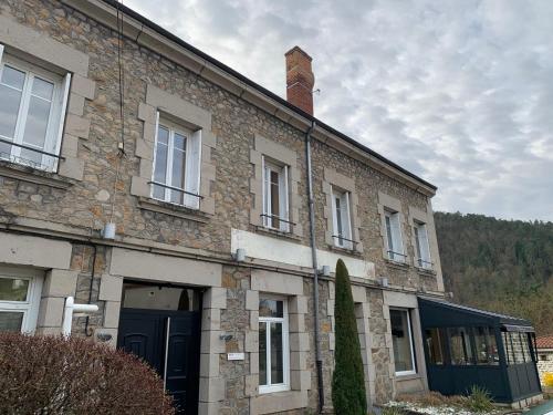 an old brick building with a chimney on top of it at L’air du temps in Beauzac