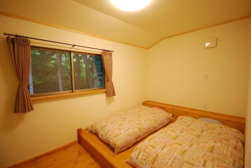 a bedroom with a bed and a window at Cottage All Resort Service / Vacation STAY 8401 in Inawashiro