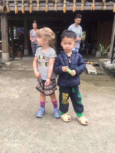 a boy and a girl standing next to each other at Tày Cốc Pảng Homestay in Làng Cac