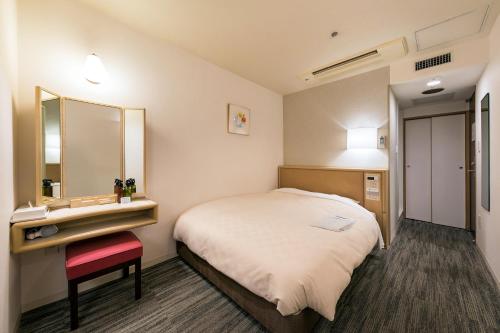 En eller flere senge i et værelse på Ginza Capital Hotel Akane