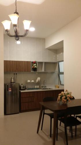 a kitchen with a table and a stainless steel refrigerator at Barrington Square 2 Rooms Apartment at Golden Hill Night Market in Brinchang