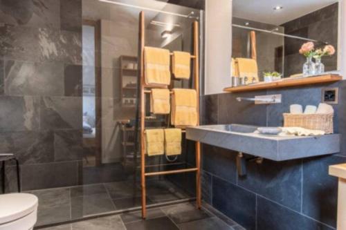 a bathroom with a sink and a shower at Ferienwohnung Chasa Arpiglia in Guarda