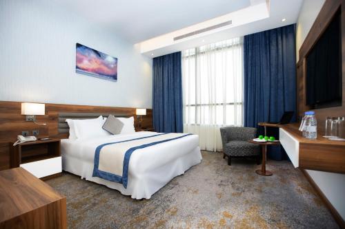 a hotel room with a bed and a desk at Eva Hotel in Jeddah