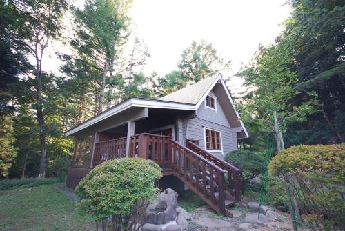 a small house with a deck in the woods at Cottage All Resort Service / Vacation STAY 8441 in Inawashiro