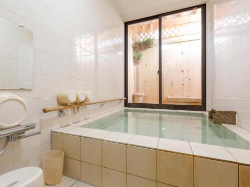 Kylpyhuone majoituspaikassa Tabist International Hotel Kaike
