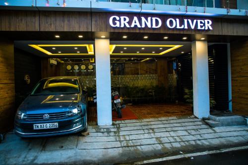 a car parked in front of a building at Grand Oliver in Chennai